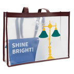 Transparente Tasche mit bordeauxfarbenem Rand; bedruckt mit gelb‑grünen Leselampen und großem weißen Schriftzug „SHINE BRIGHT!“.
