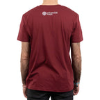 Rückansicht einer Person im bordeauxfarbenen T‑Shirt. Am oberen Rücken ist in Weiß das Logo „Universität Wien“ aufgedruckt.